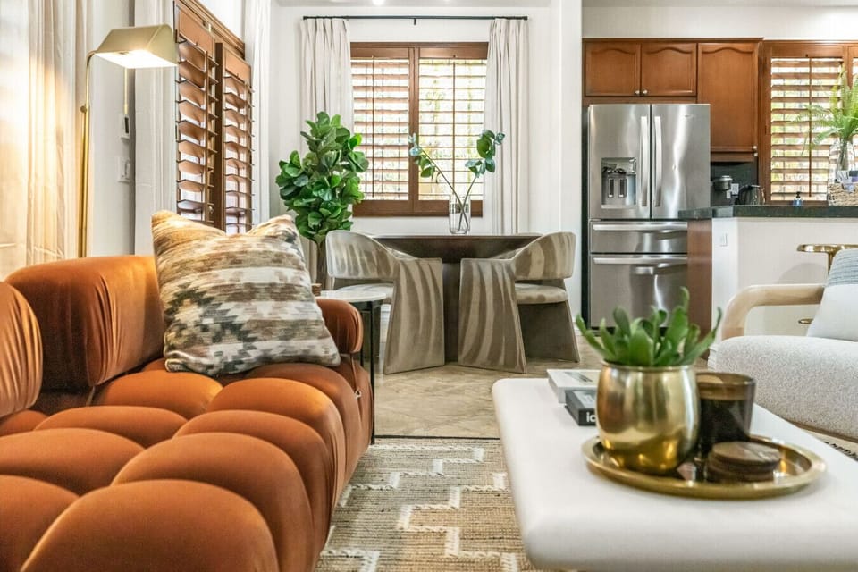Stylish living space w/ comfy sofas, curated decor & open sightlines to the kitchen—great for gathering together.