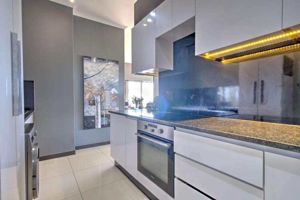 Kitchen: Enjoy a modern kitchen where sleek design meets functionality, enhanced by bright, inviting lighting that creates the perfect setting for your culinary adventures.