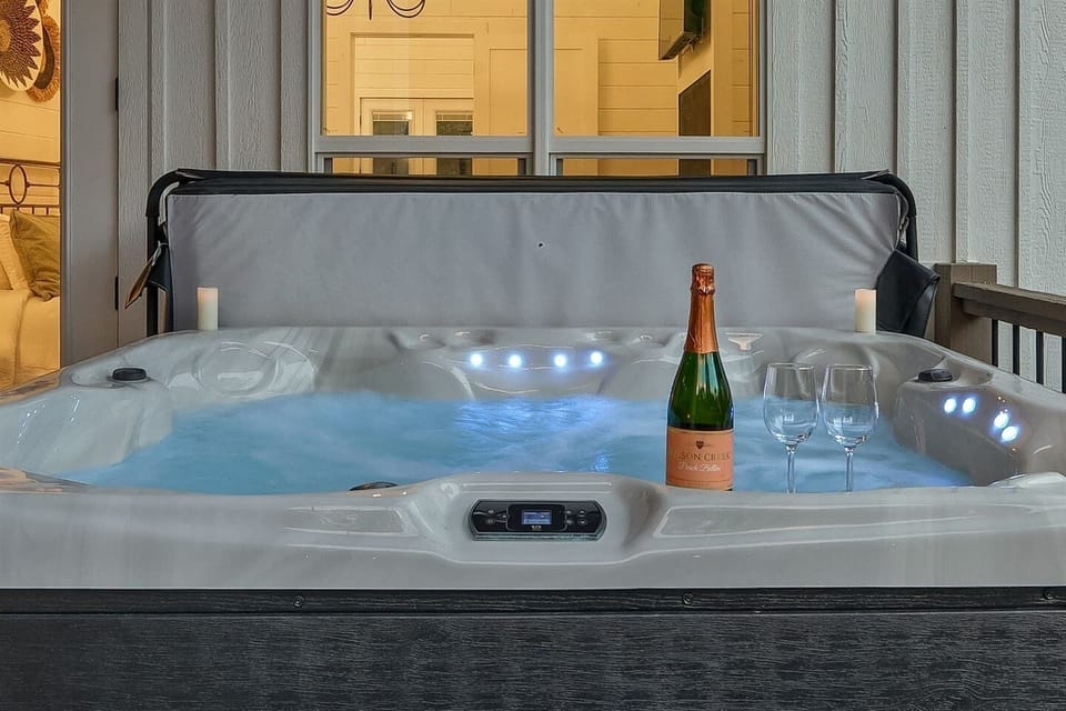 Soak under the stars in your private hot tub, surrounded by string lights and peaceful forest views.