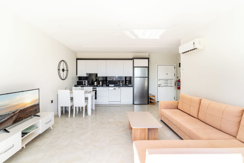 The living room, dining table and open style fully equiped kitchen