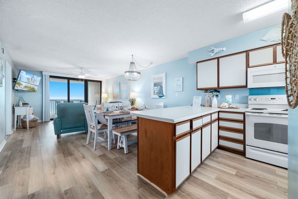 Subtle coastal touches and a neutral palette create a serene and relaxing ambiance in this open living and dining space.