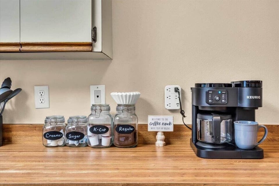 Coffee station stocked with complimentary coffee, K-Cups, creamer, and sugar