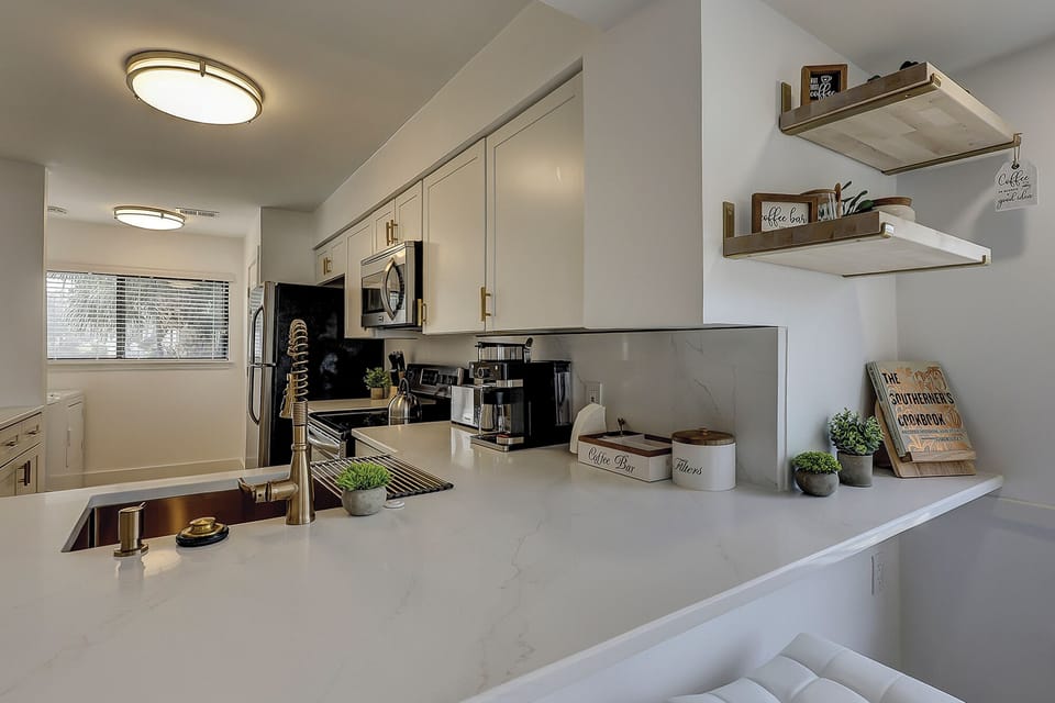 Fully stocked kitchen with stainless steel appliances. Also included is a wireless charging port.