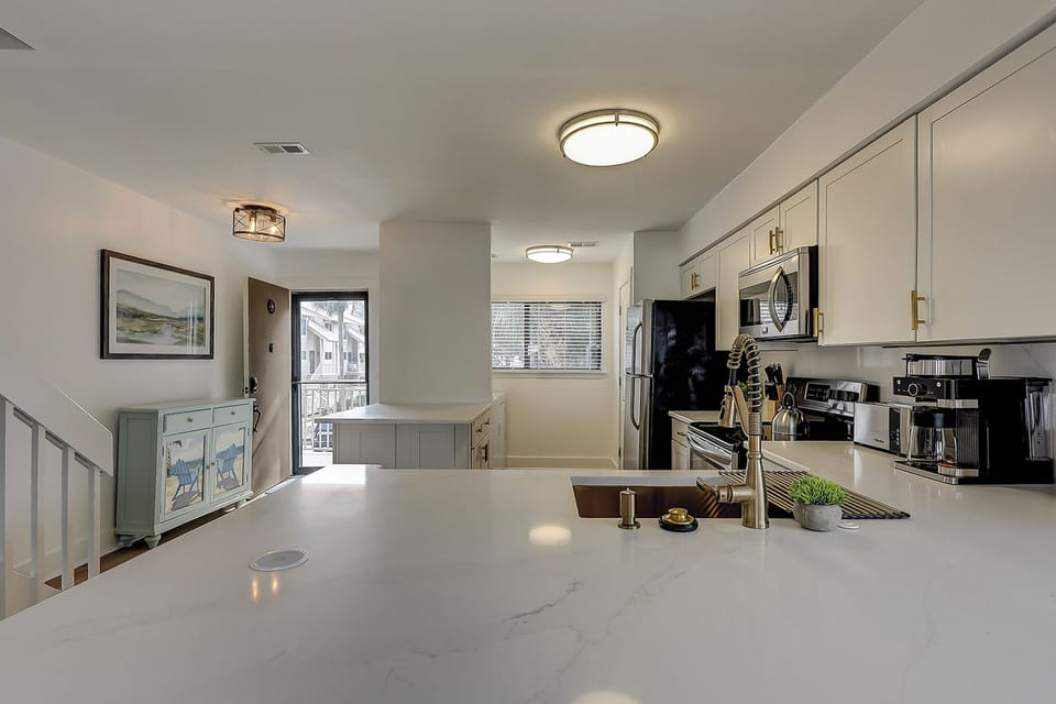 Fully stocked kitchen with stainless steel appliances. Also included is a wireless charging port.