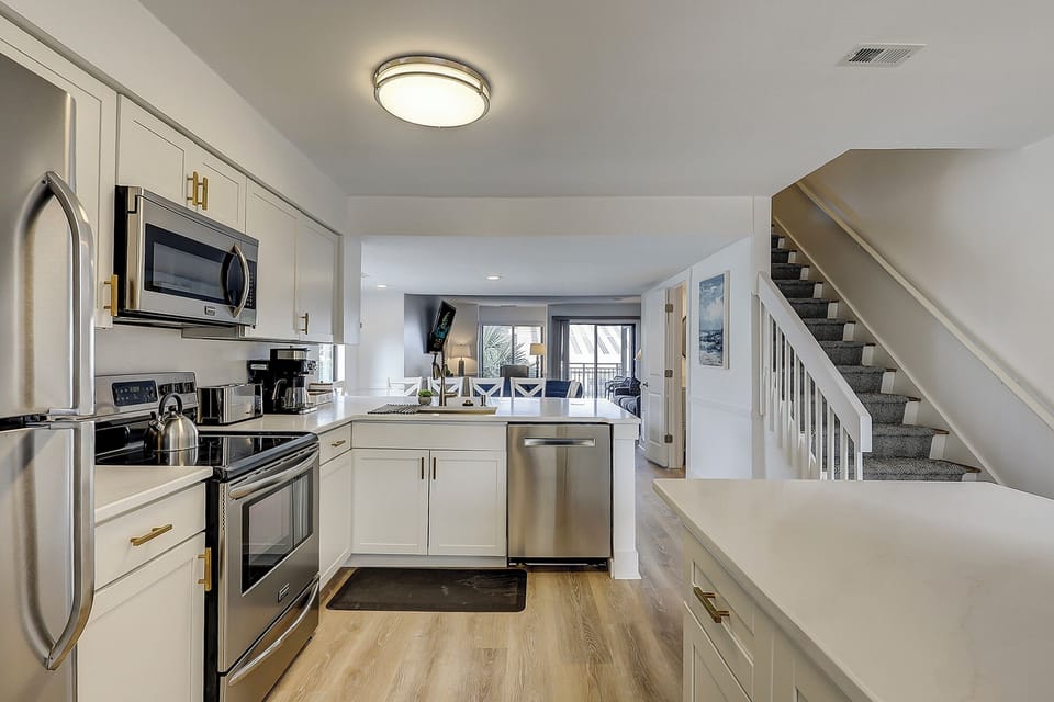 Fully stocked kitchen with stainless steel appliances. Also included is a wireless charging port.