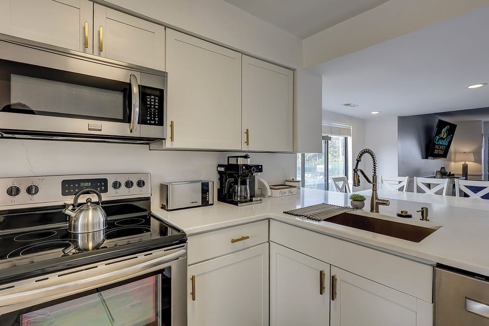 Fully stocked kitchen with stainless steel appliances. Also included is a wireless charging port.