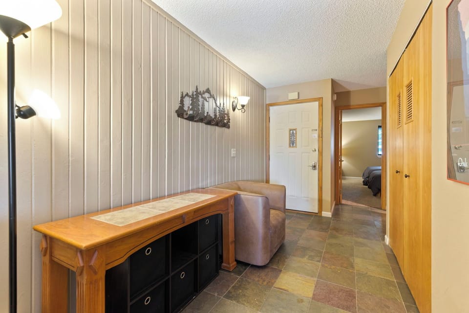 Entryway foyer with seat to remove shoes while seated.