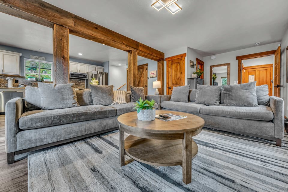 Living room: Two sofas, 70” Smart TV, wood-burning fireplace