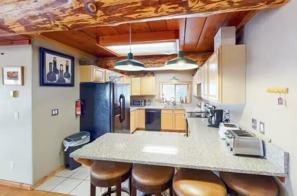 Kitchen: Main floor, drip coffee maker, toaster, Crockpot, cooking utensils, tableware