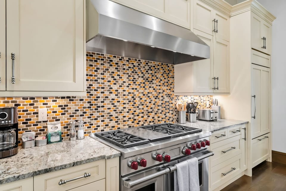 Kitchen: Main floor, Sub-Zero fridge, Wolf range, Keurig and drip coffee maker, Crockpot, toaster, cooking utensils, tableware