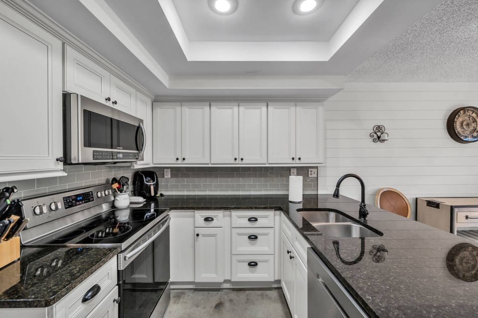 Bright modern kitchen with stainless appliances – fully equipped for cooking meals during your stay.