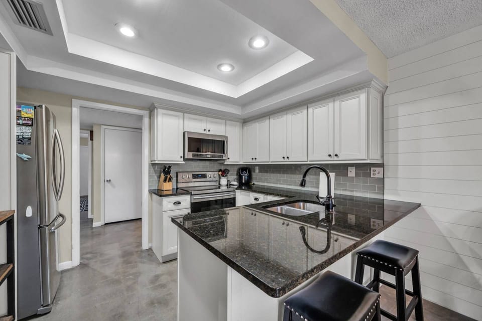 Beautifully designed kitchen with a cozy bar seating area for two — perfect for morning coffee or a casual meal.