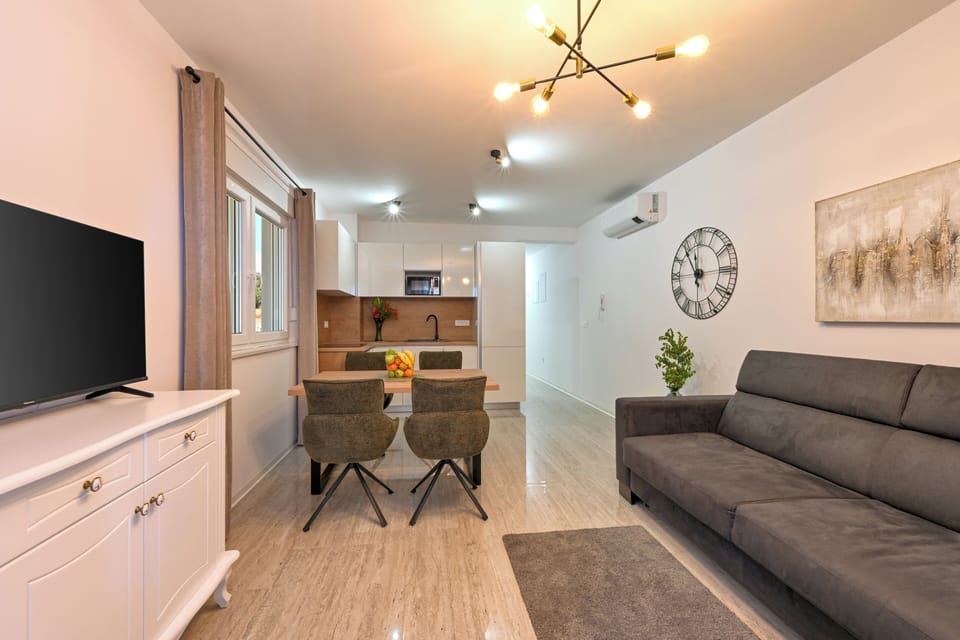Deluxe Apartment, Balcony, Partial Sea View | Living area | TV