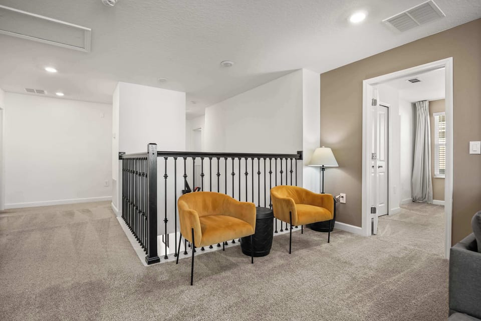 Relax in this cozy seating area with stylish chairs and soft lighting, perfect for unwinding after a day of exploring.