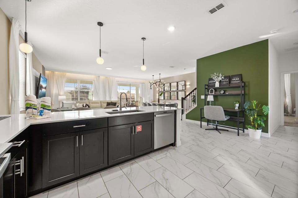 Experience open-concept living with a modern kitchen and cozy lounge area, perfect for gatherings.
