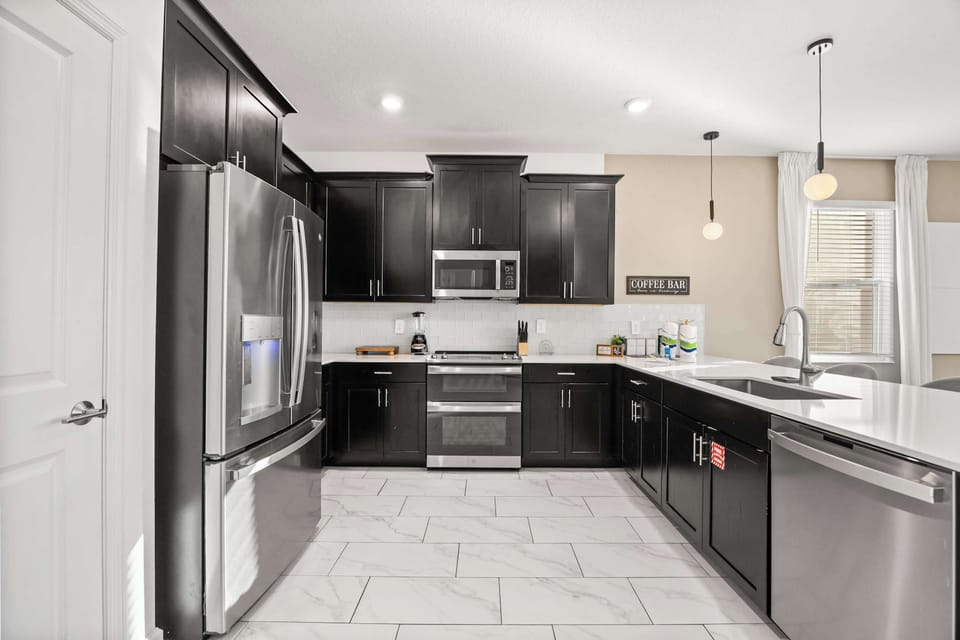 Sleek modern kitchen with stainless steel appliances and a spacious island, perfect for cooking and entertaining.