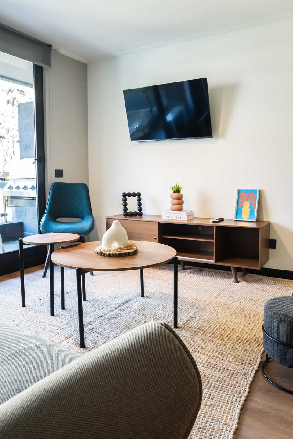 Unwind in this chic living room with a sleek TV and stylish decor, perfect for relaxation.
