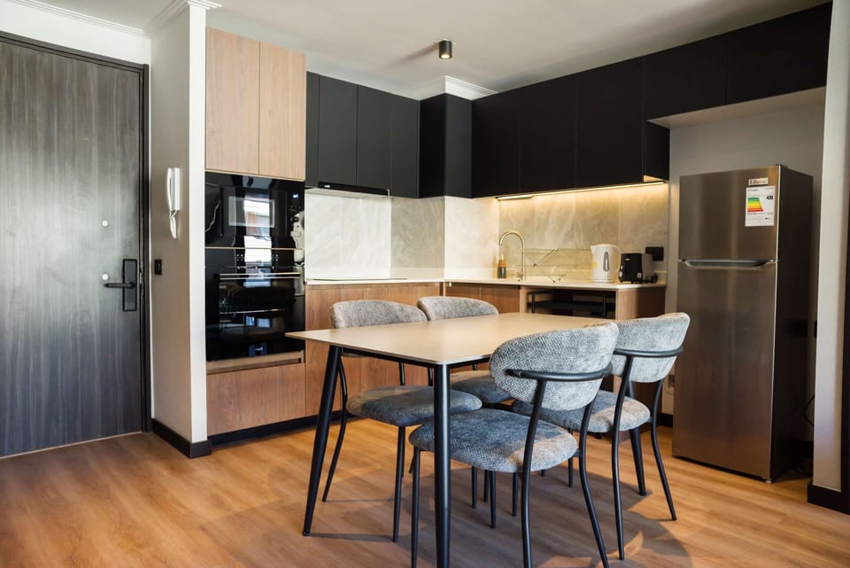 Stylish kitchen with modern appliances and cozy dining area, perfect for enjoying meals together.