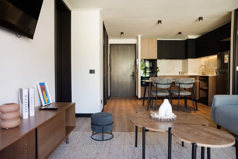 Stylish and modern living area with a cozy dining space and sleek kitchen, perfect for relaxing and entertaining.