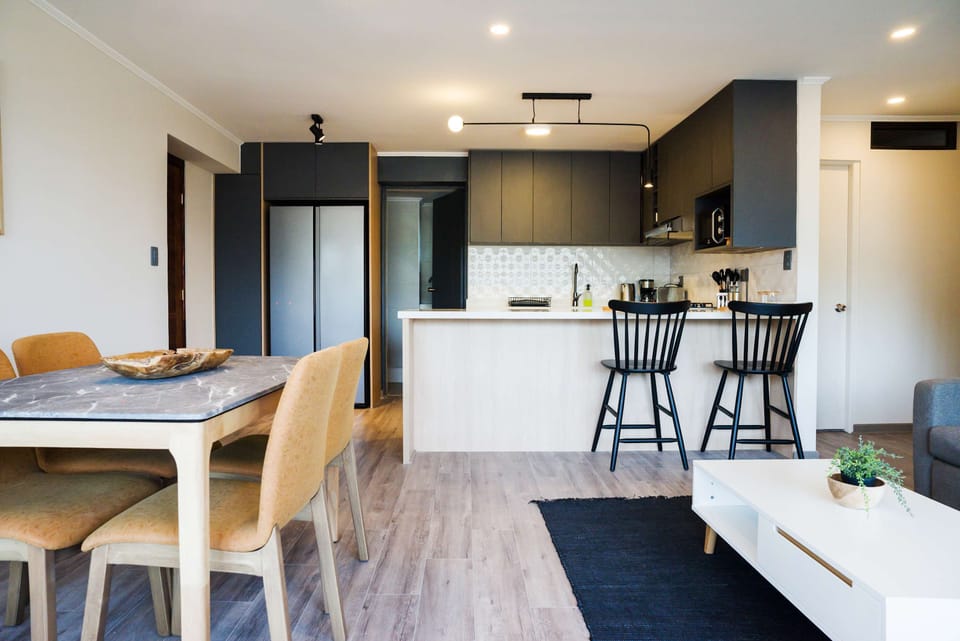 Enjoy the open-plan design that seamlessly connects the dining area, the breakfast bar, and the modern kitchen. This contemporary space is perfectly laid out for cooking, sharing meals, and socializing with your entire group.