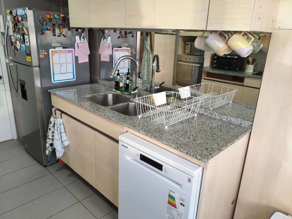 Modern kitchen with granite countertops and stainless steel appliances, perfect for preparing meals during your stay.