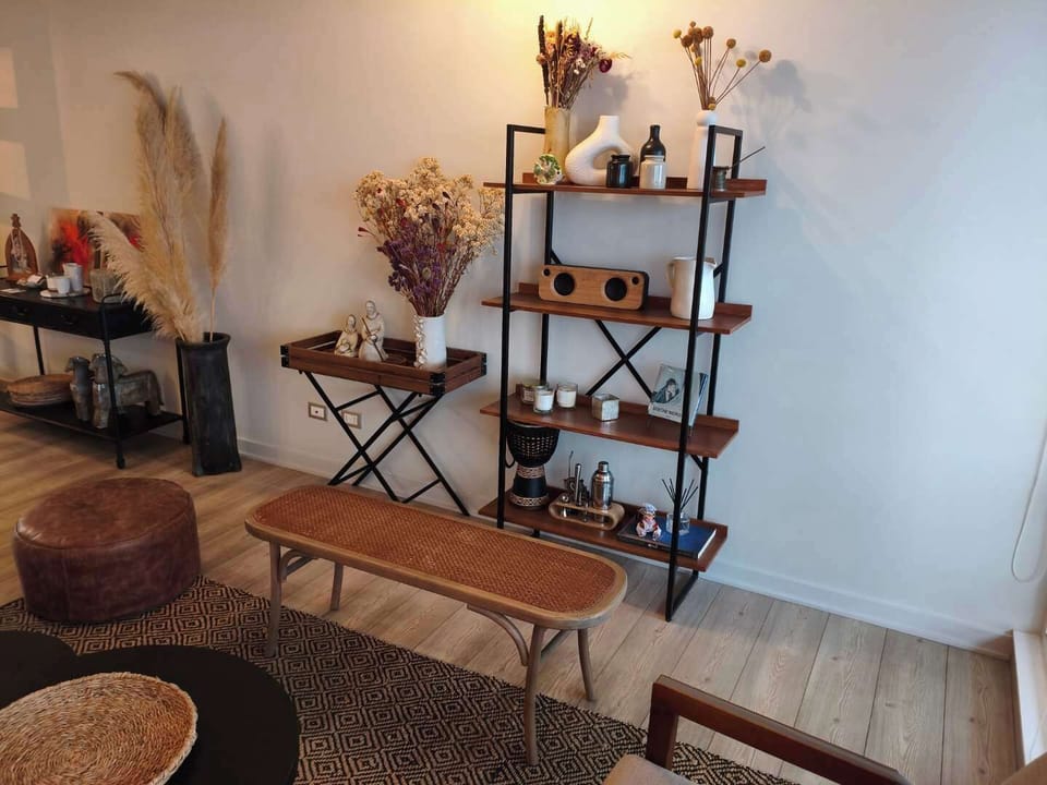 Charming living area with stylish decor and cozy seating, perfect for relaxation.
