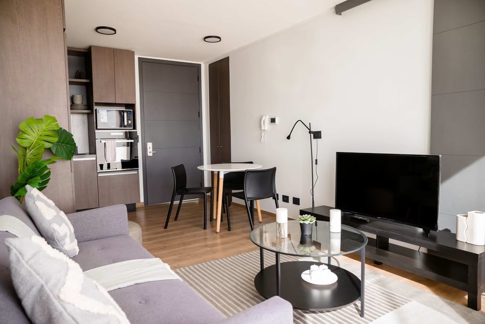 Cozy modern living room with sleek furnishings and natural light, perfect for relaxation and entertainment.