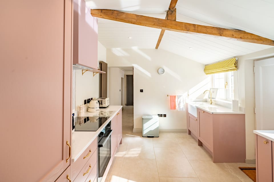 Ground floor: Light and airy kitchen with access to the enclosed garden and sauna