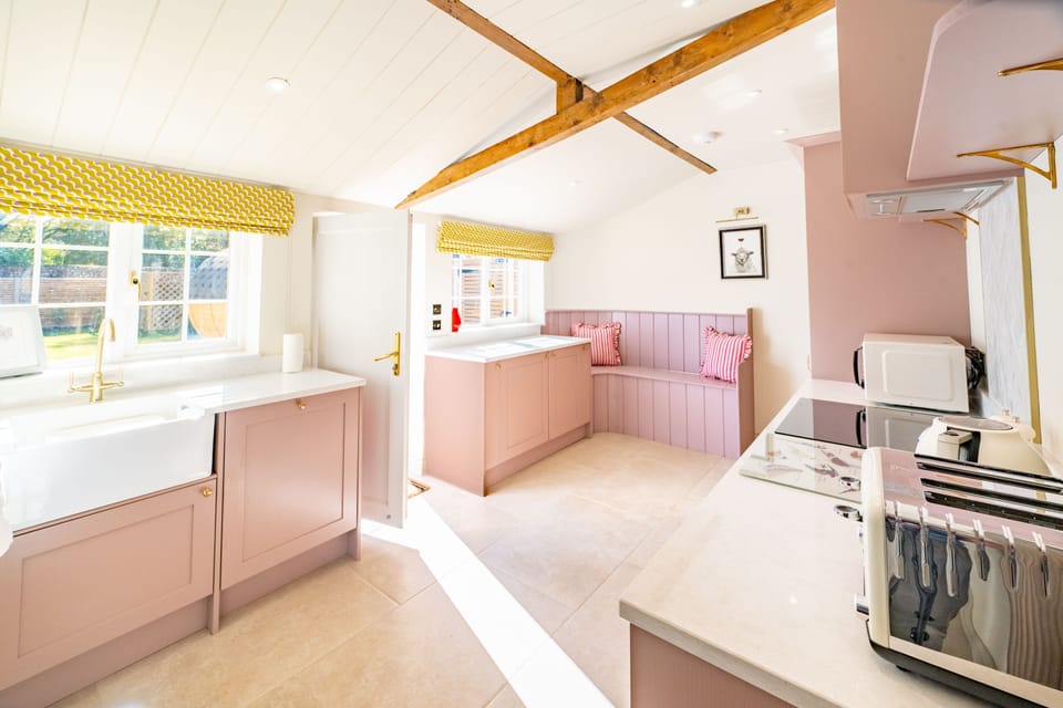 Ground floor: Light and airy kitchen with access to the enclosed garden and sauna