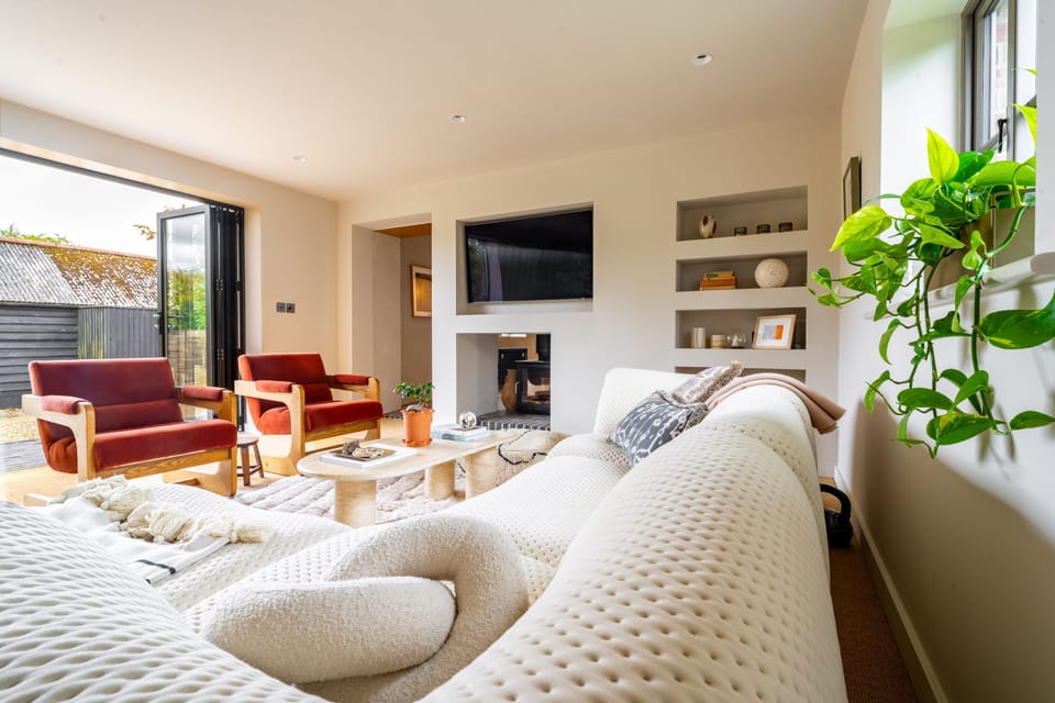 Ground floor: Sitting room with double-sided wood burning stove and doors to the garden