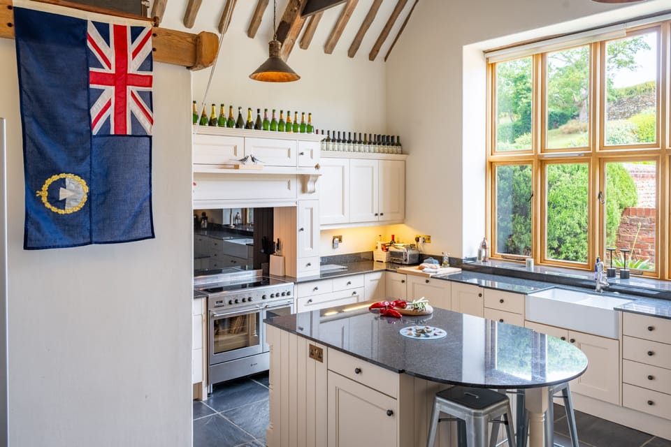 Ground floor: Kitchen with a Range oven with electric hob, coffee machine, dishwasher, fridge/freezer, microwave, washer/dryer, toaster, breakfast bar island and sofa