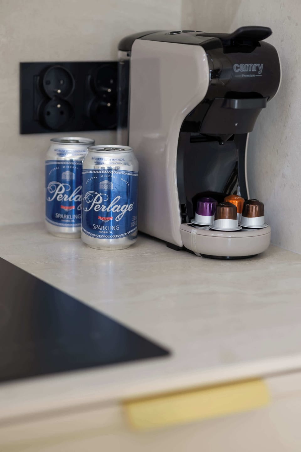The coffee machine and beverages on the counter add a cozy touch, inviting you to enjoy a calm morning with your favorite drink.