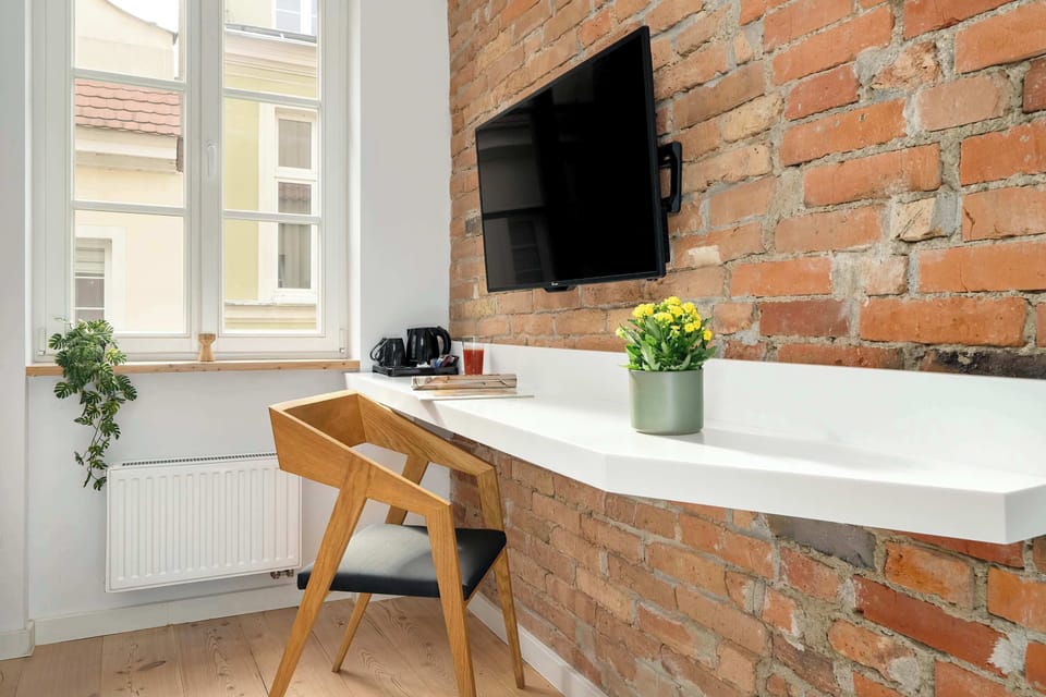 A desk with a chair creates a comfortable corner for working and studying in front of the computer.