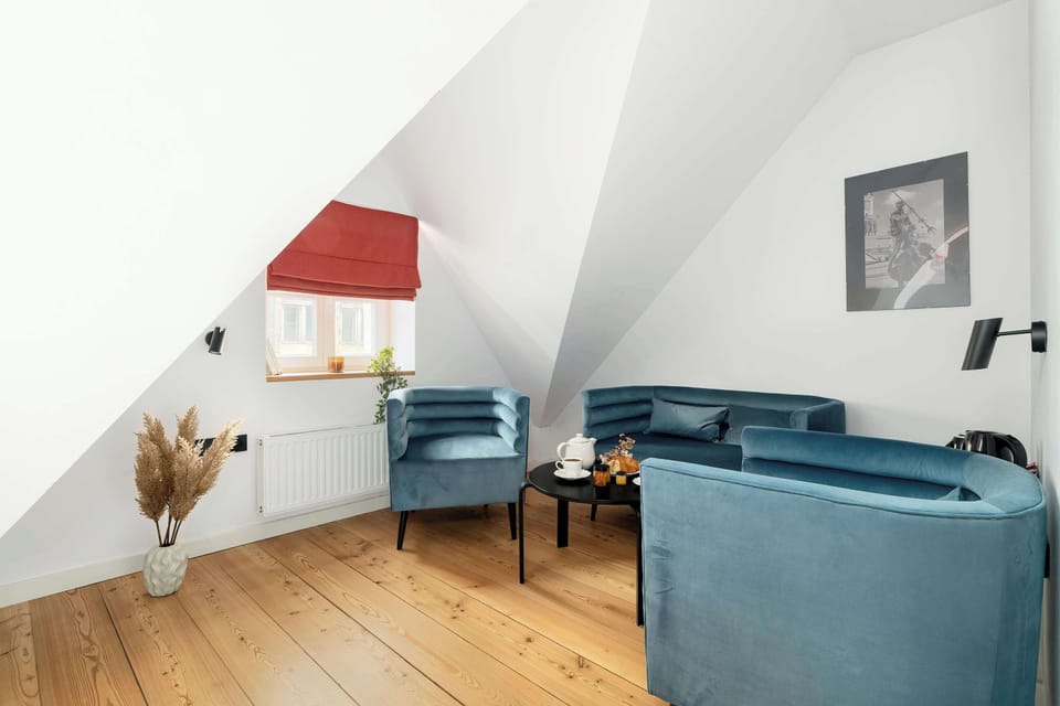 A seating area with a comfortable sofa, armchairs and coffee table.