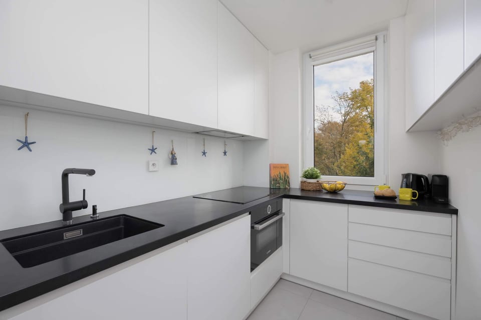 The kitchen's sleek design includes all necessary cookware and utensils.