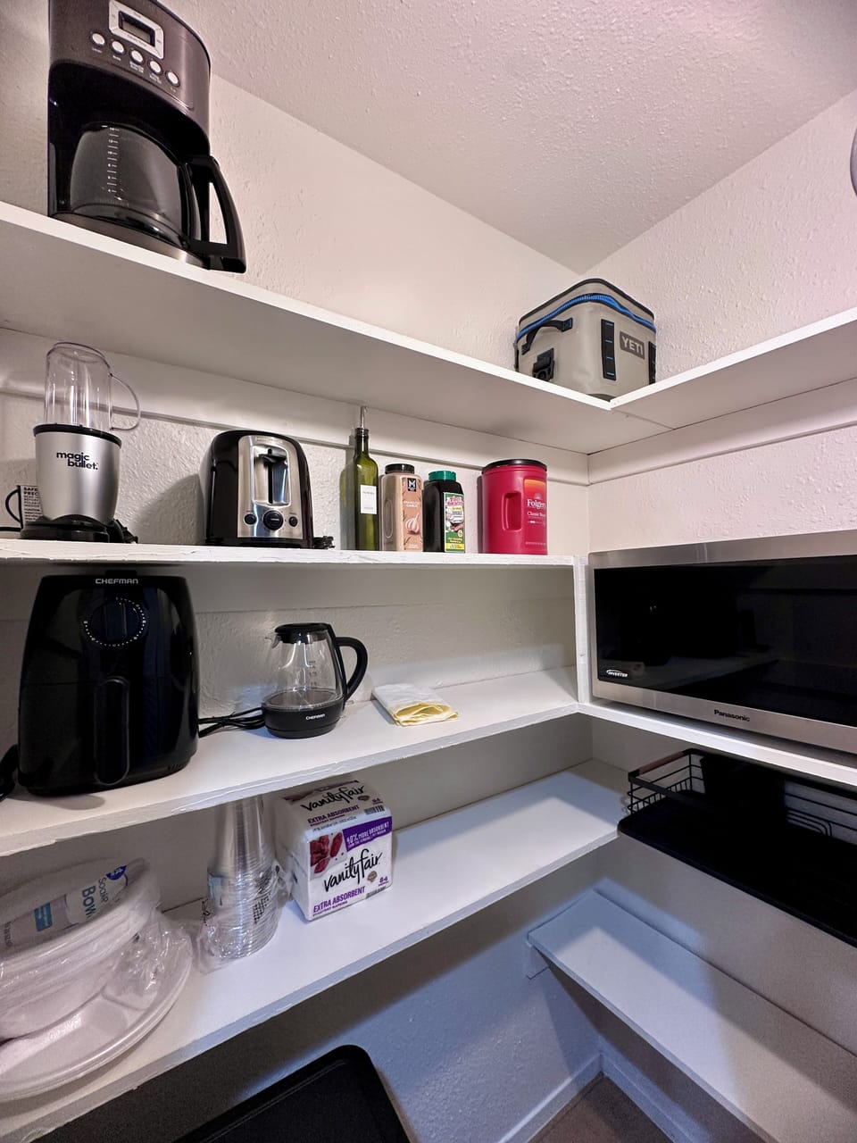 Pantry with full size microwave, coffee pot, blender, toaster, air fryer etc