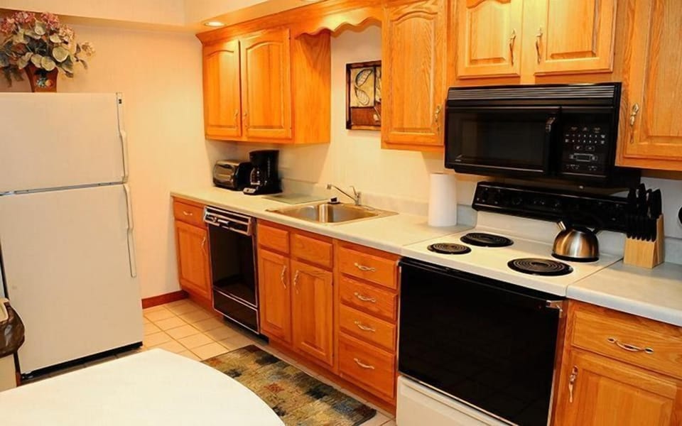 The kitchen showcases modern appliances and oak cabinetry, providing a functional and welcoming space for meal preparation.