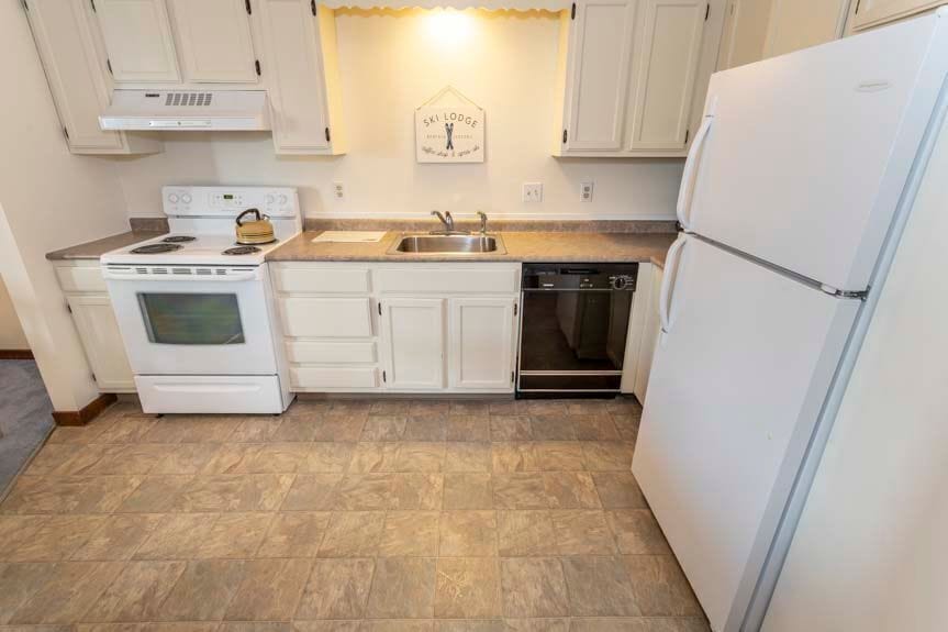 The kitchen is well-appointed with modern appliances, ample counter space, and charming decor, making it a perfect spot for meal preparation.