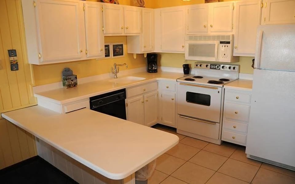 The bright, thoughtfully laid-out kitchen features modern appliances and ample counter space, ideal for cooking and gathering.