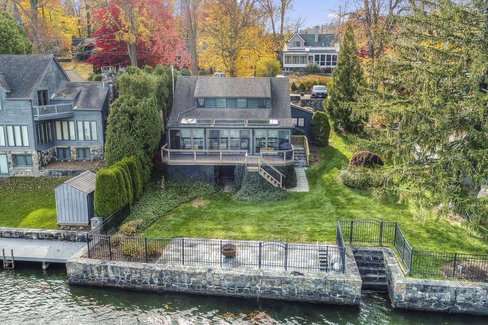 Right on the water’s edge—dock, green lawn, and multiple spots to relax lakeside.