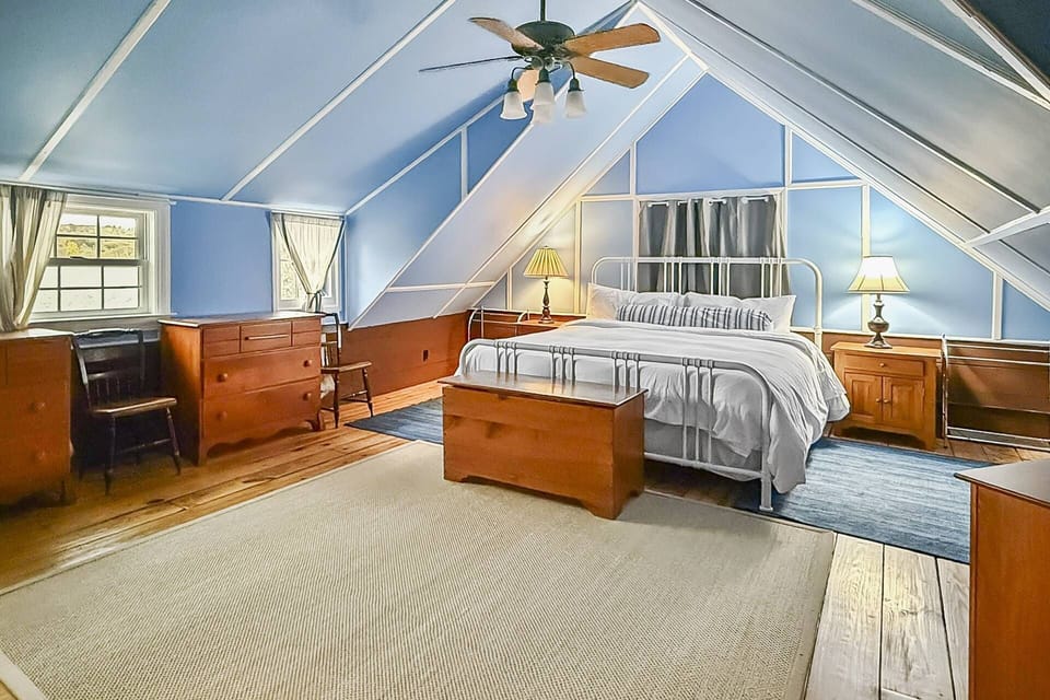 Spacious primary suite with a king bed and peaceful lake views.