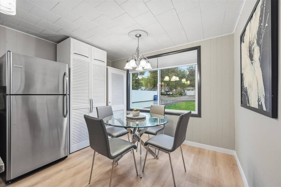 Eat-in kitchen with round dining table seats four comfortably (2 additional bar stools at kitchen island)