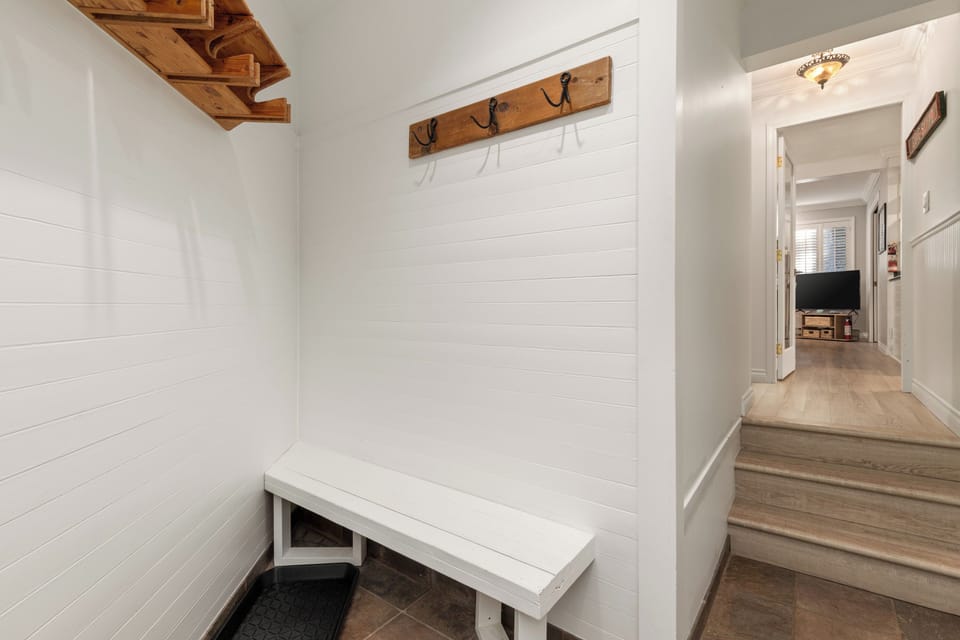 Front foyer with ski/snowboard storage and hallway to the rest of the home