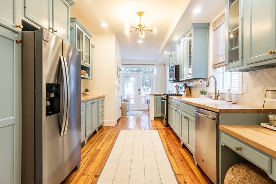 The stunning remodeled kitchen blends the historic pine floors with the modern cabinetry and appliances.