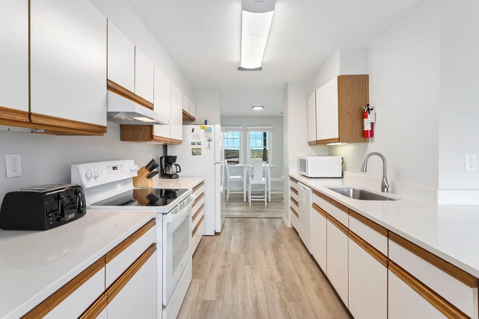 Cook up your favorite coastal meals in the well-stocked kitchen featuring modern appliances and plenty of prep space.