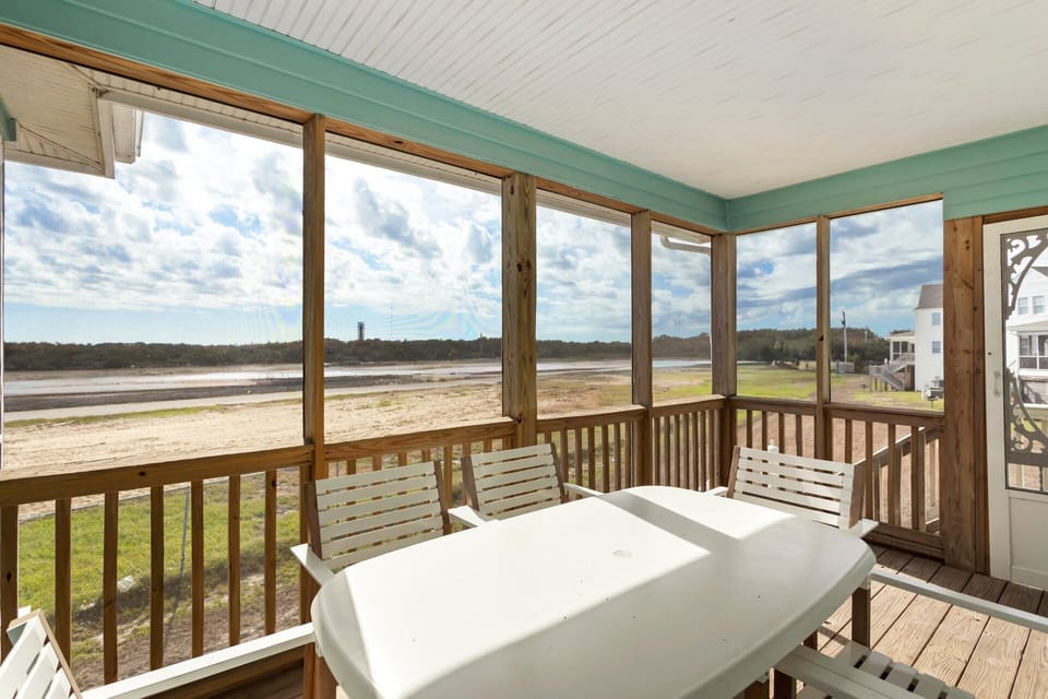 Relax and enjoy the fresh Outer Banks breeze from the screened porch, a peaceful spot to sip your morning coffee or unwind after a day at the beach.