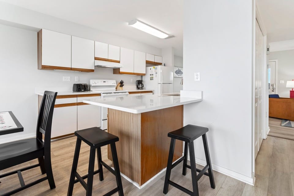 Cook up your favorite coastal meals in the well-stocked kitchen featuring modern appliances and plenty of prep space.