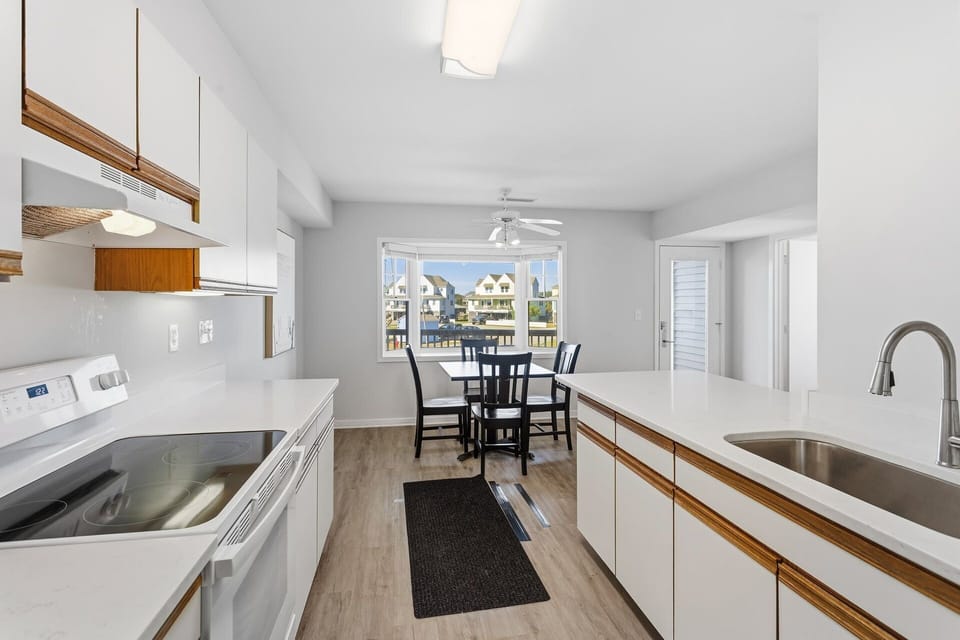 Cook with ease in the fully stocked kitchen featuring modern appliances, ample counter space, and a friendly open layout.