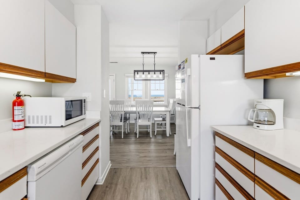 Cook with ease in the fully stocked kitchen featuring modern appliances, ample counter space, and a friendly open layout.