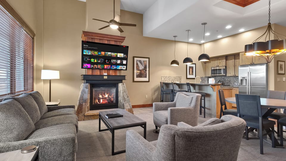Open living area with kitchen access and queen sofa bed sleeping space